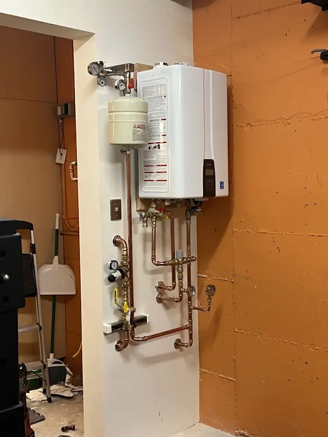 Plumbing technician inspecting water heater connections in Sebastopol